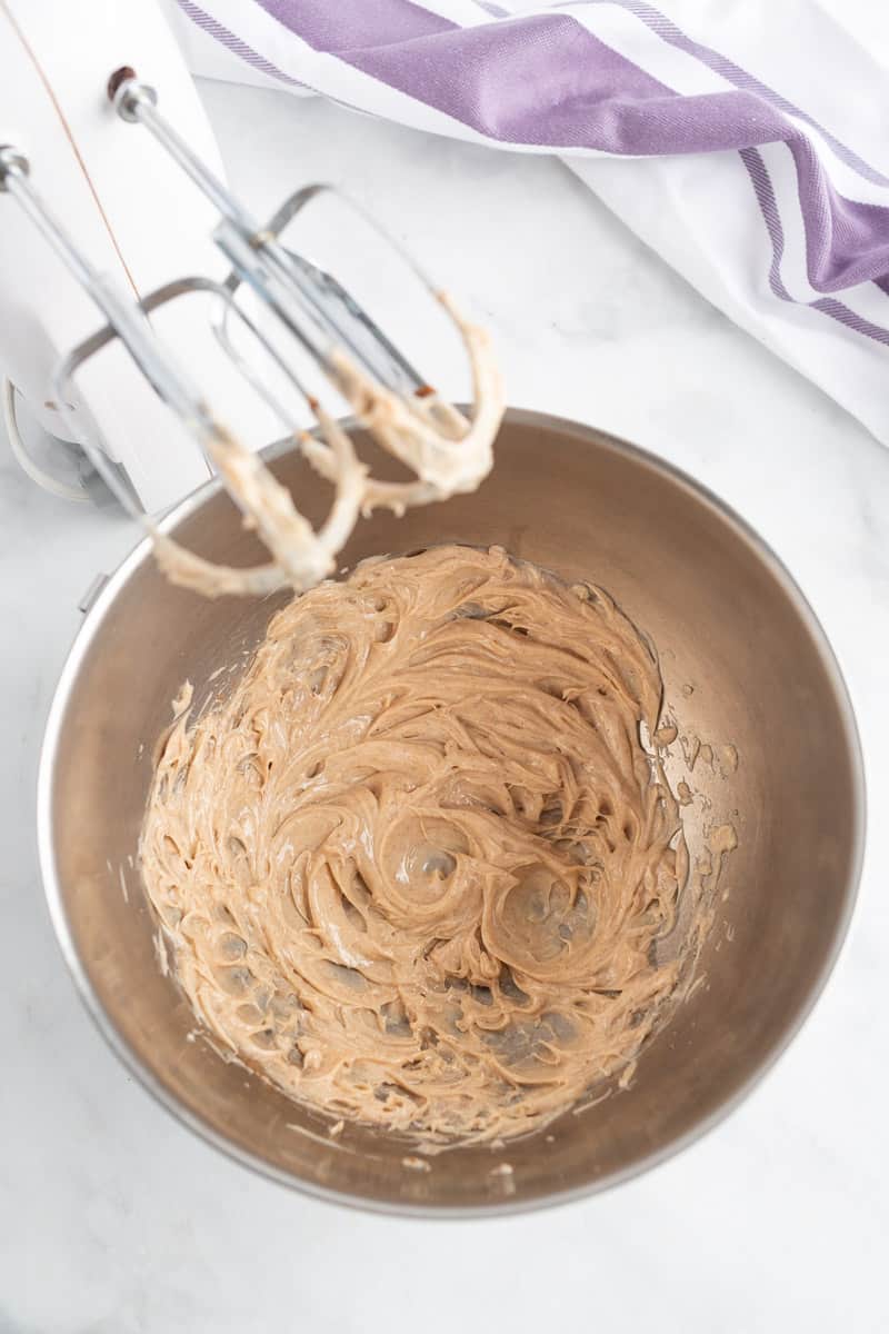 Cinnamon maple butter in a silver bowl, electric mixer also visible.