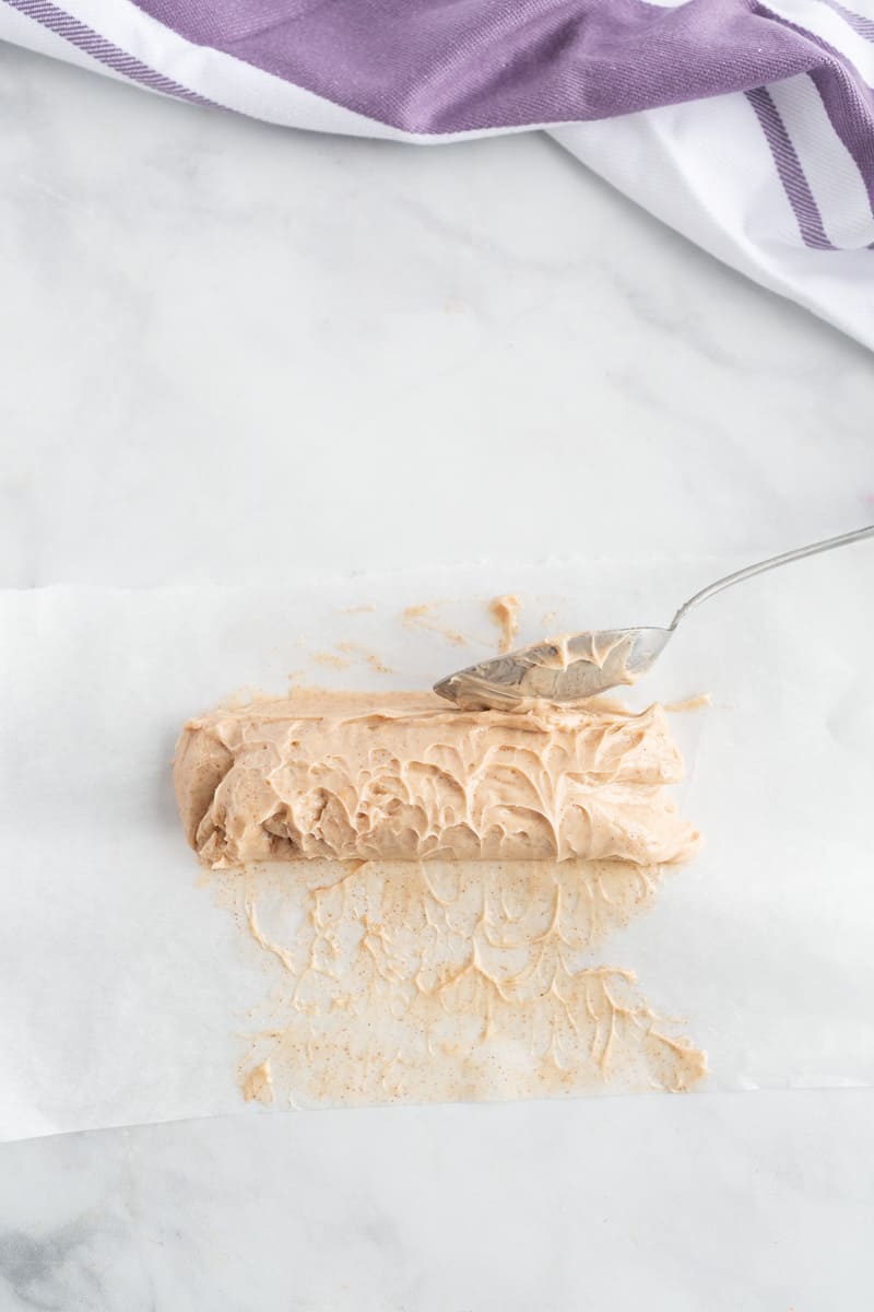 Vanilla maple cinnamon butter formed into a log on parchment paper.