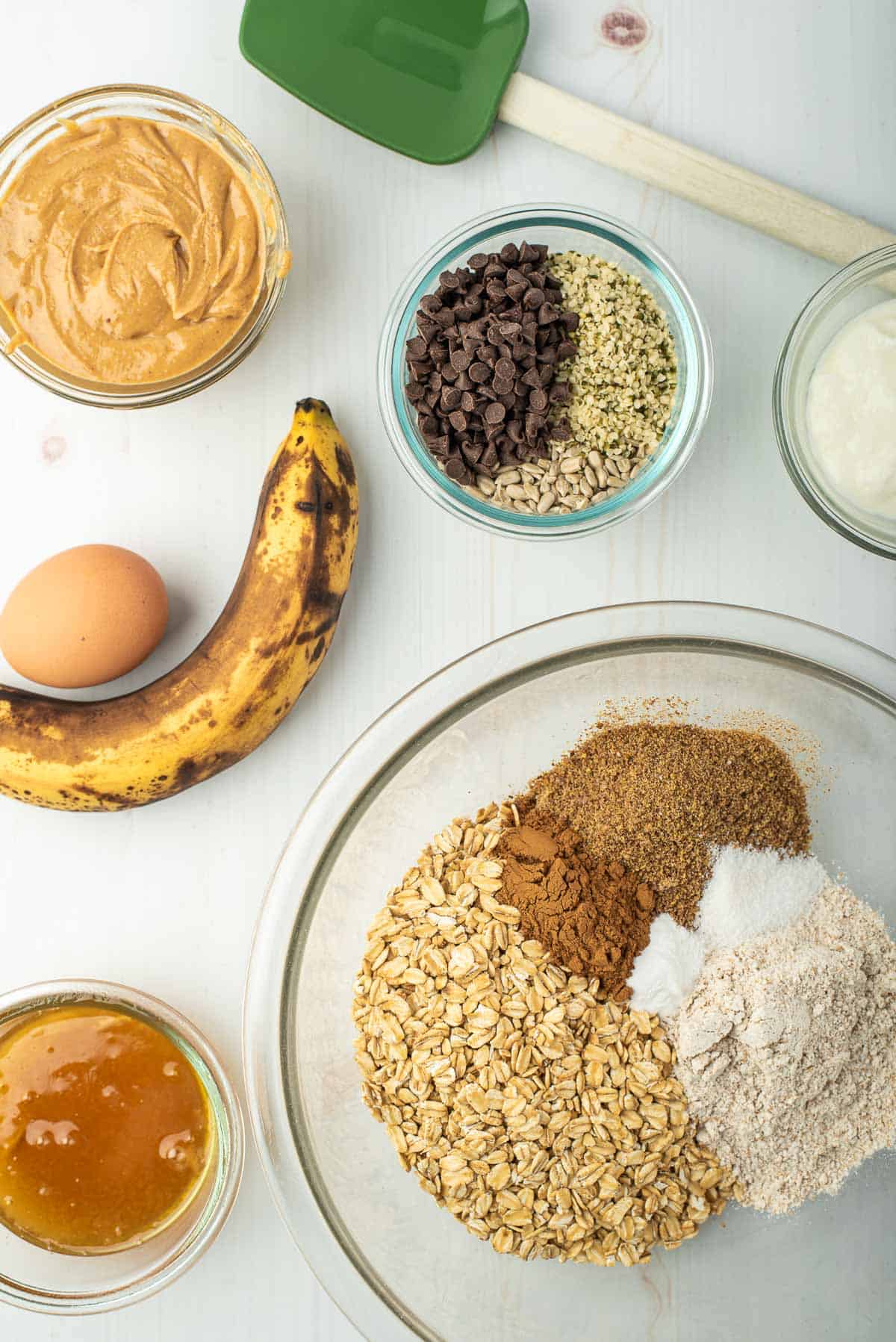 Breakfast cookie dry ingredients in a bowl, surrounded by additional ingredients.