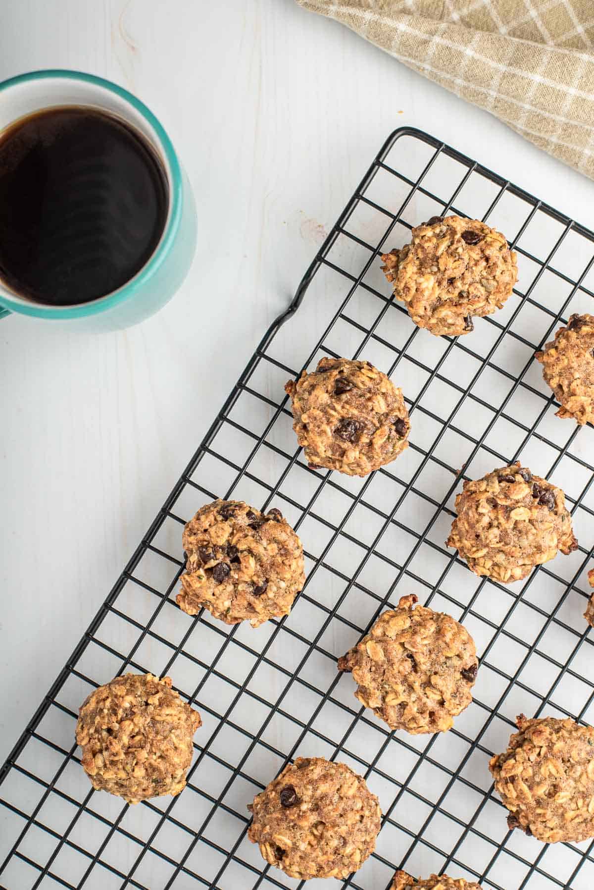 Cookies on a cooling rack, coffee also pictured.