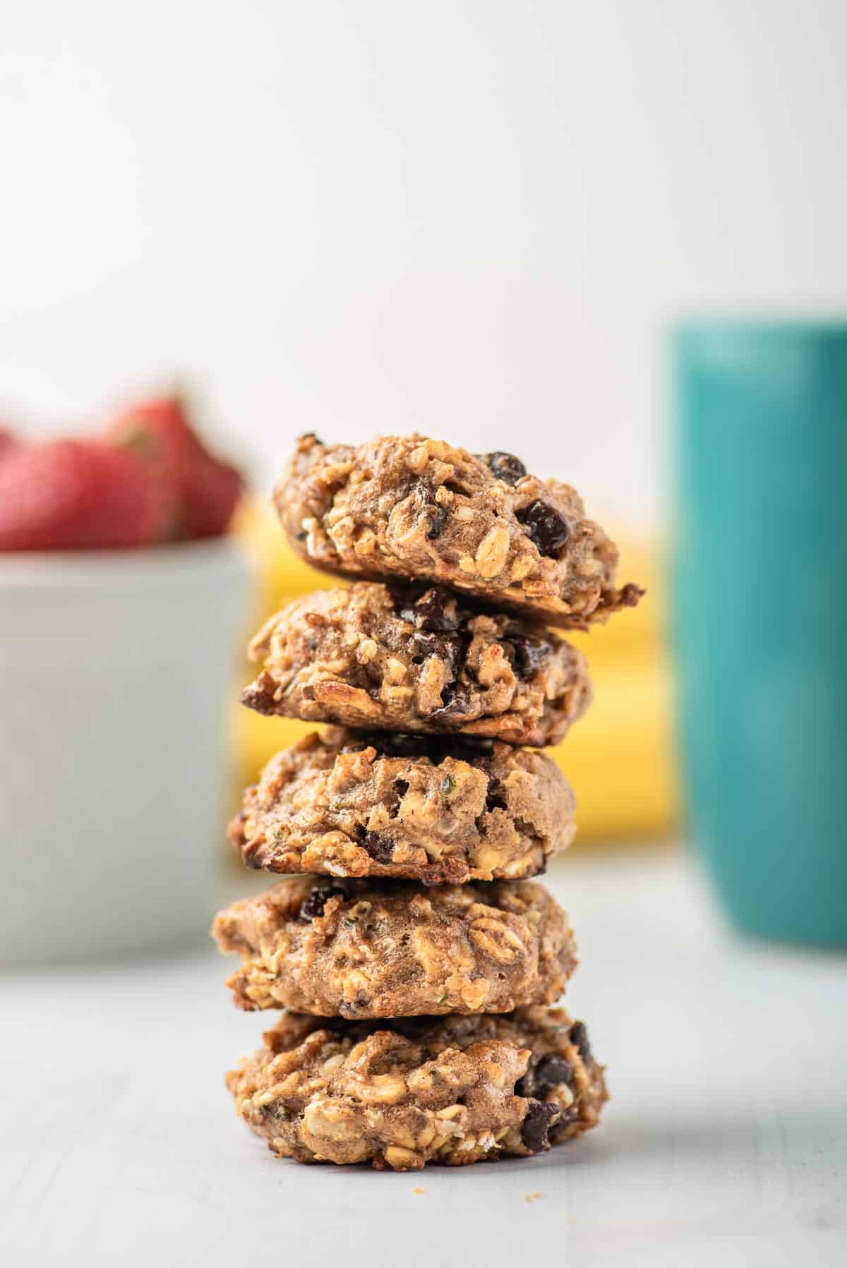 Stack of cookies with oats and chocolate chips in them.