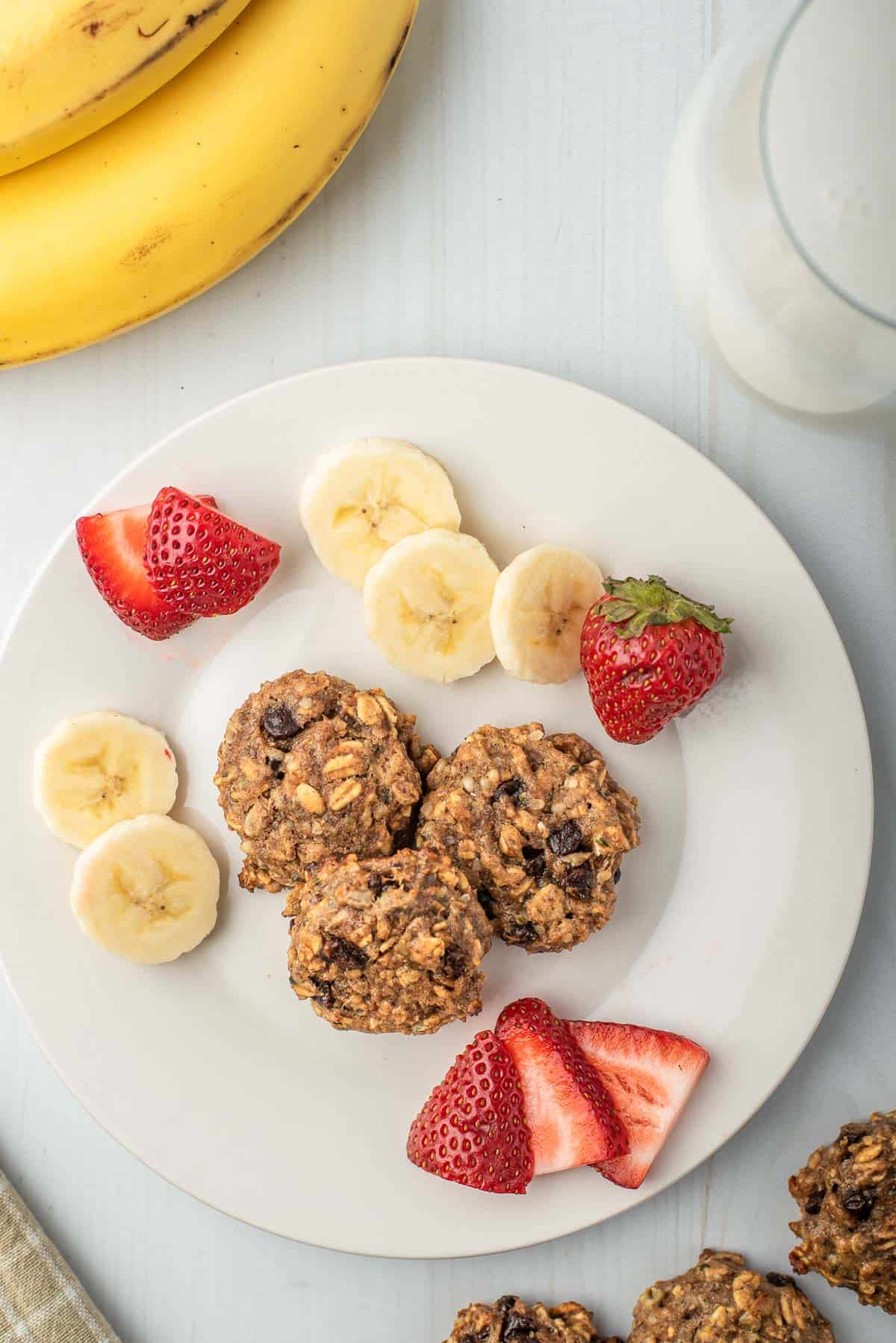 Cookies on a plate with fruit.