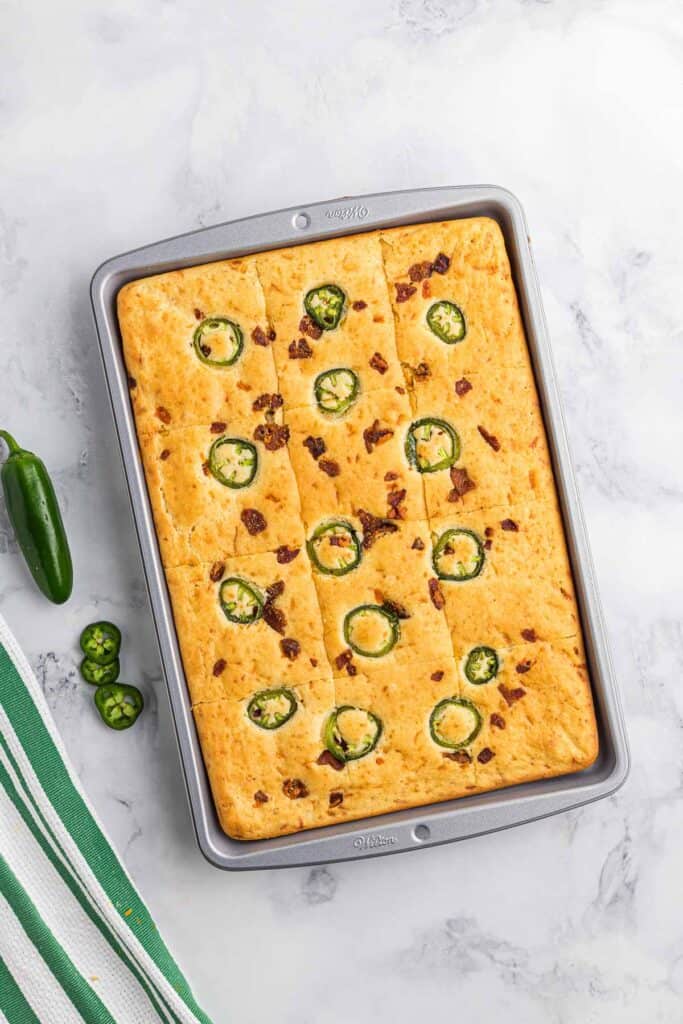 Sheet pan with pancakes made with bacon, cheddar, and jalapeno.