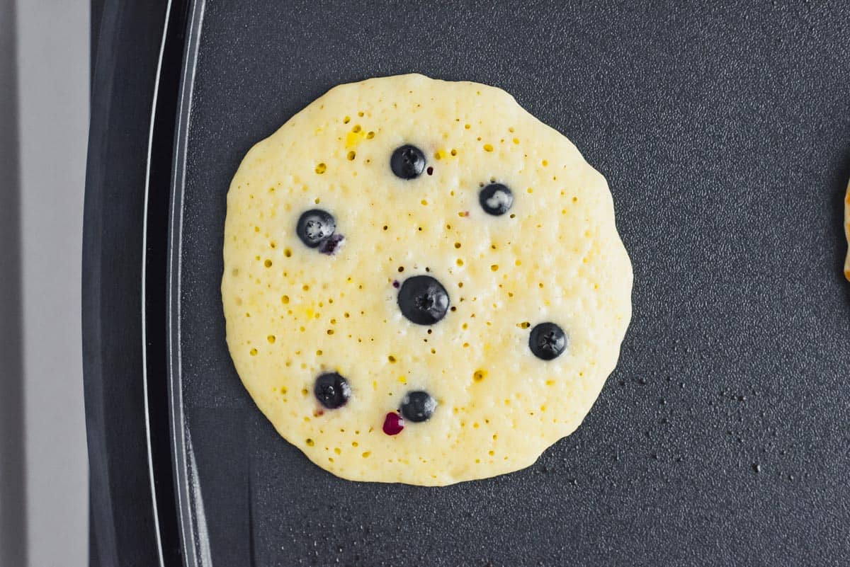 Lemon blueberry pancake on a griddle