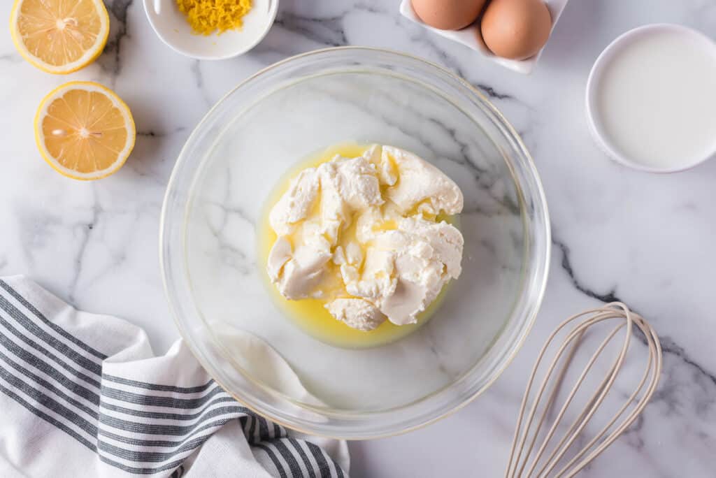 Ricotta and melted butter in a glass bowl.
