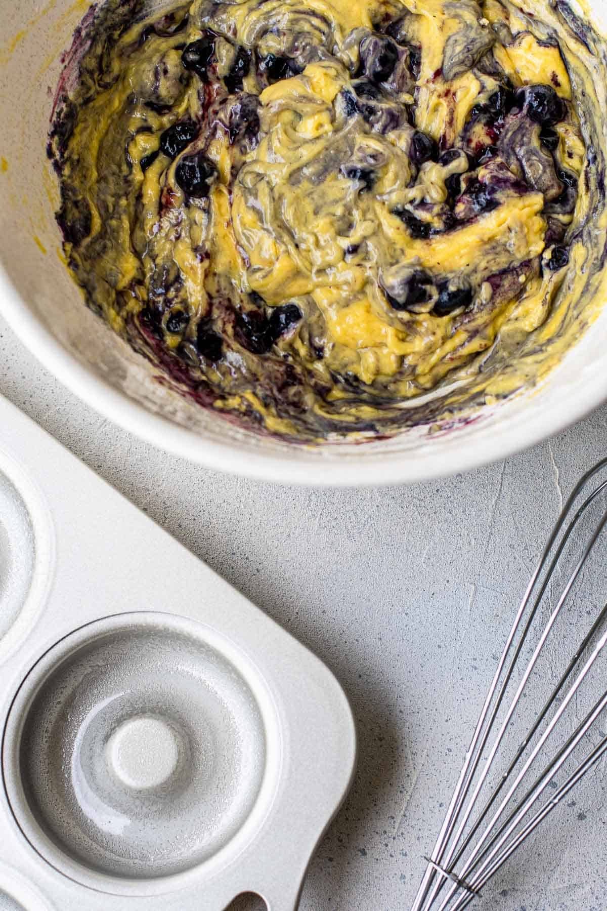 Blueberry donut batter in a mixing bowl.
