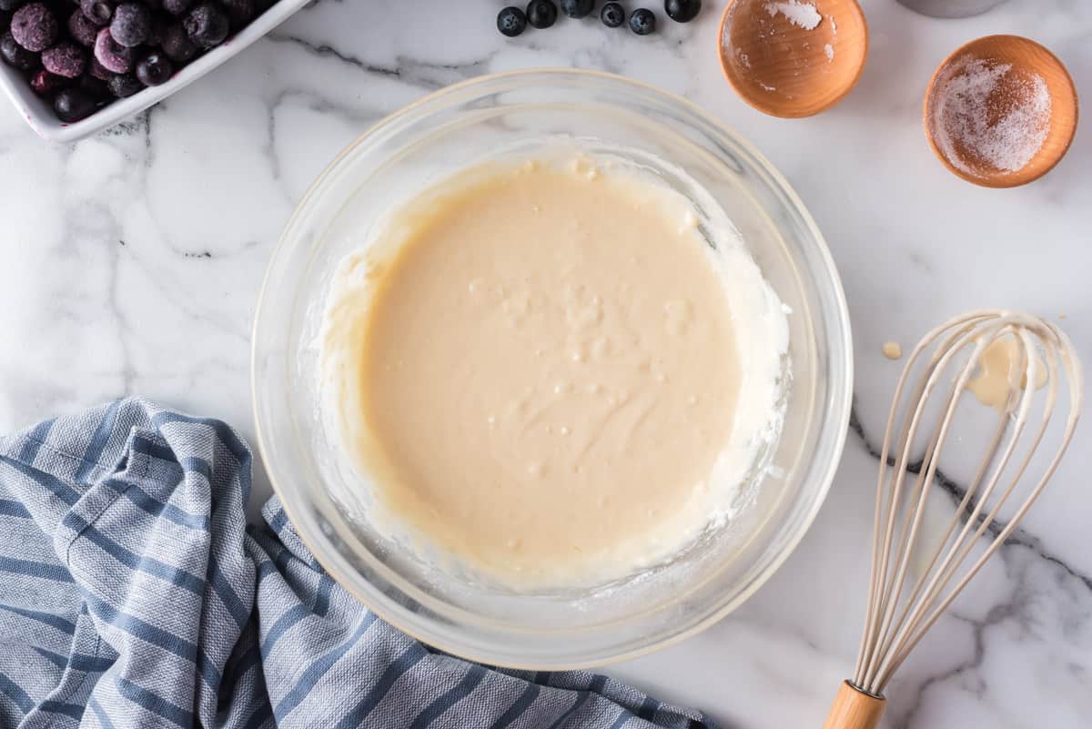 Pancake batter in a glass mixing bowl.