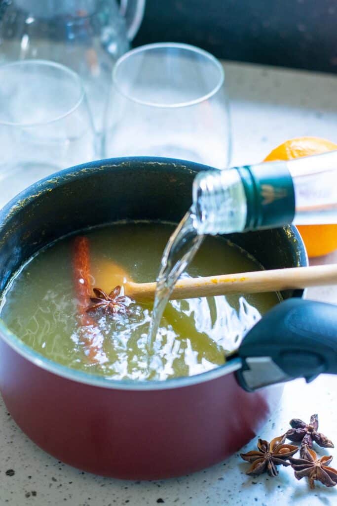 Ingredients being poured into a sauce pan.