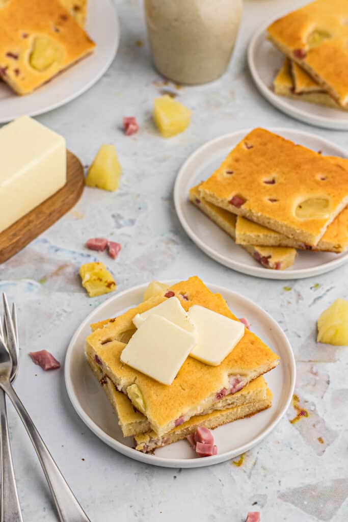 Hawaiian style sheet pan pancakes topped with generous slices of butter.