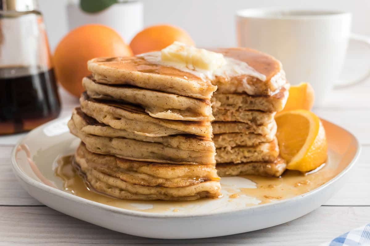 Stack of pancakes with a wedge cut out.