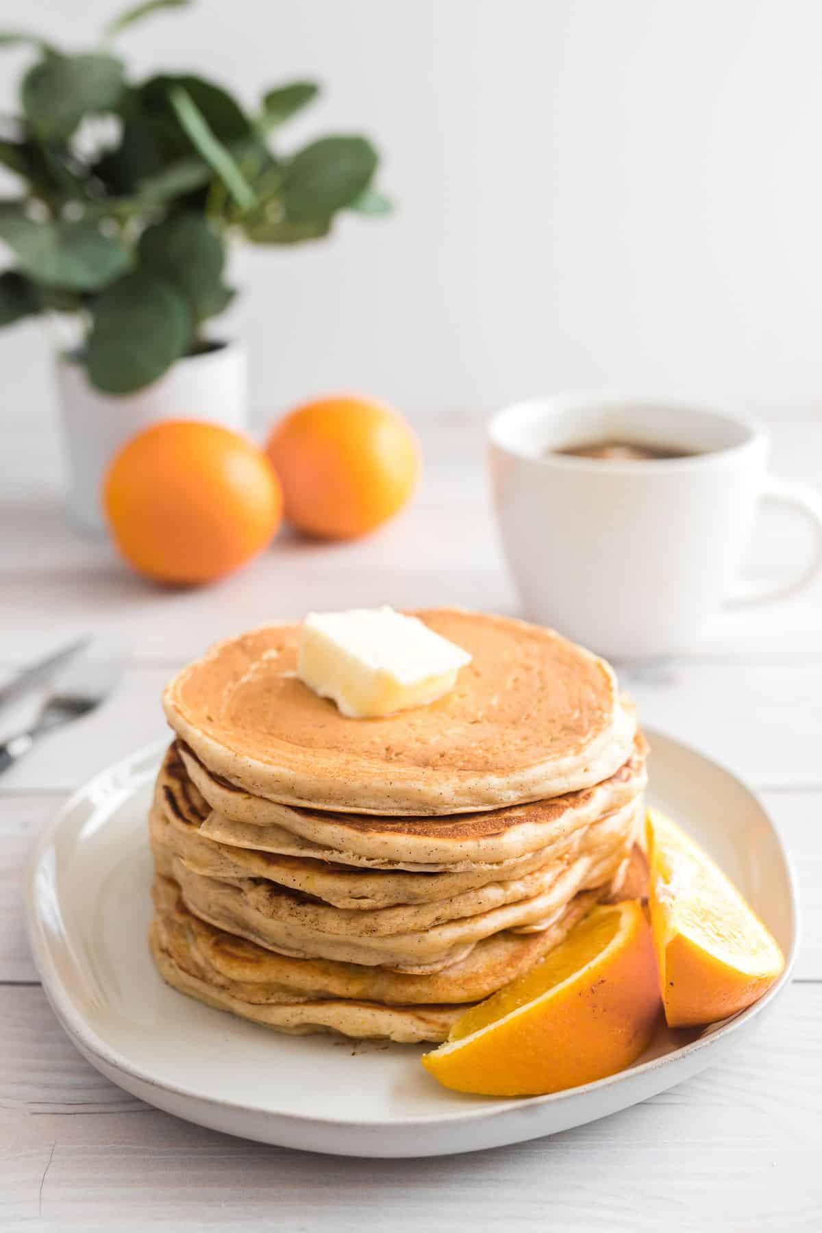 Stack of orange buttermilk pancakes.