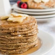 Stack of zucchini bread pancakes with butter and syrup.