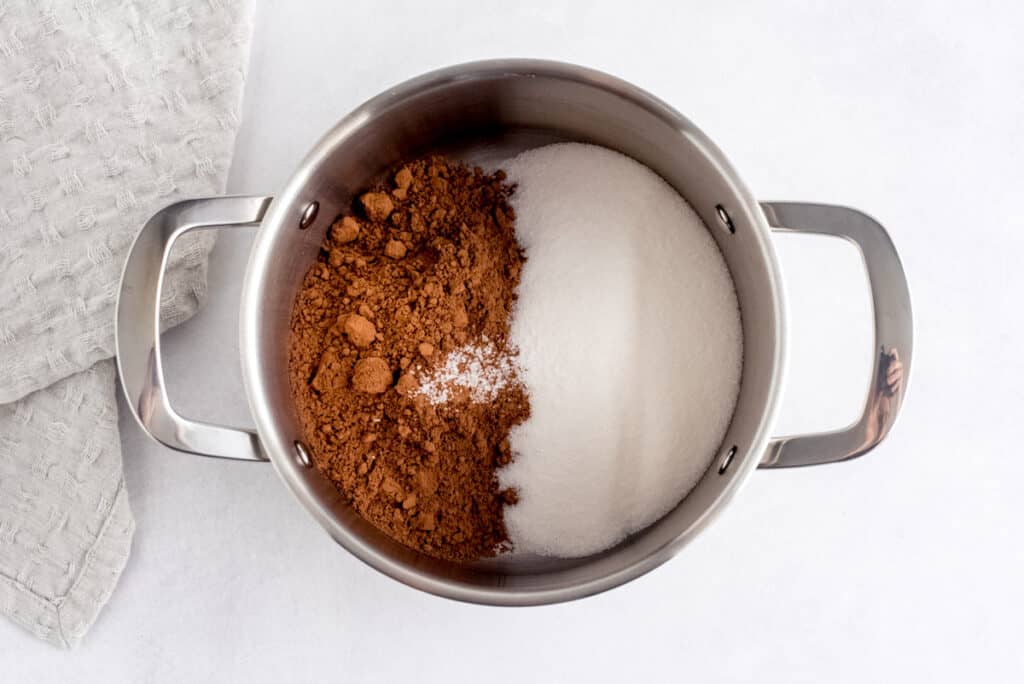 Sauce pan with sugar, salt, and cocoa powder in it.