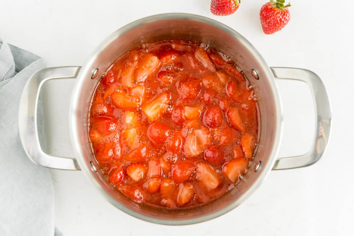 Sauce pan full of strawberry sauce.