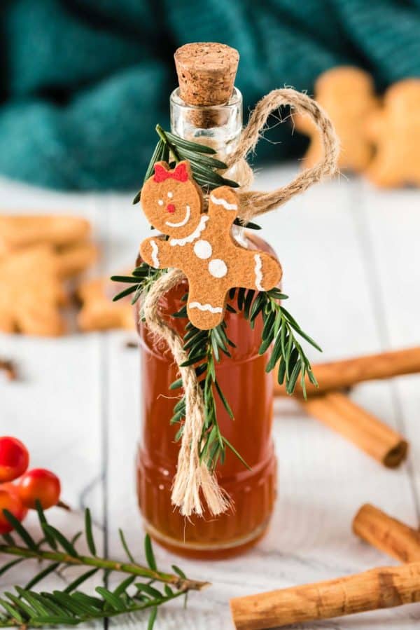 Gingerbread coffee syrup in a small glass bottle with festive decorations.
