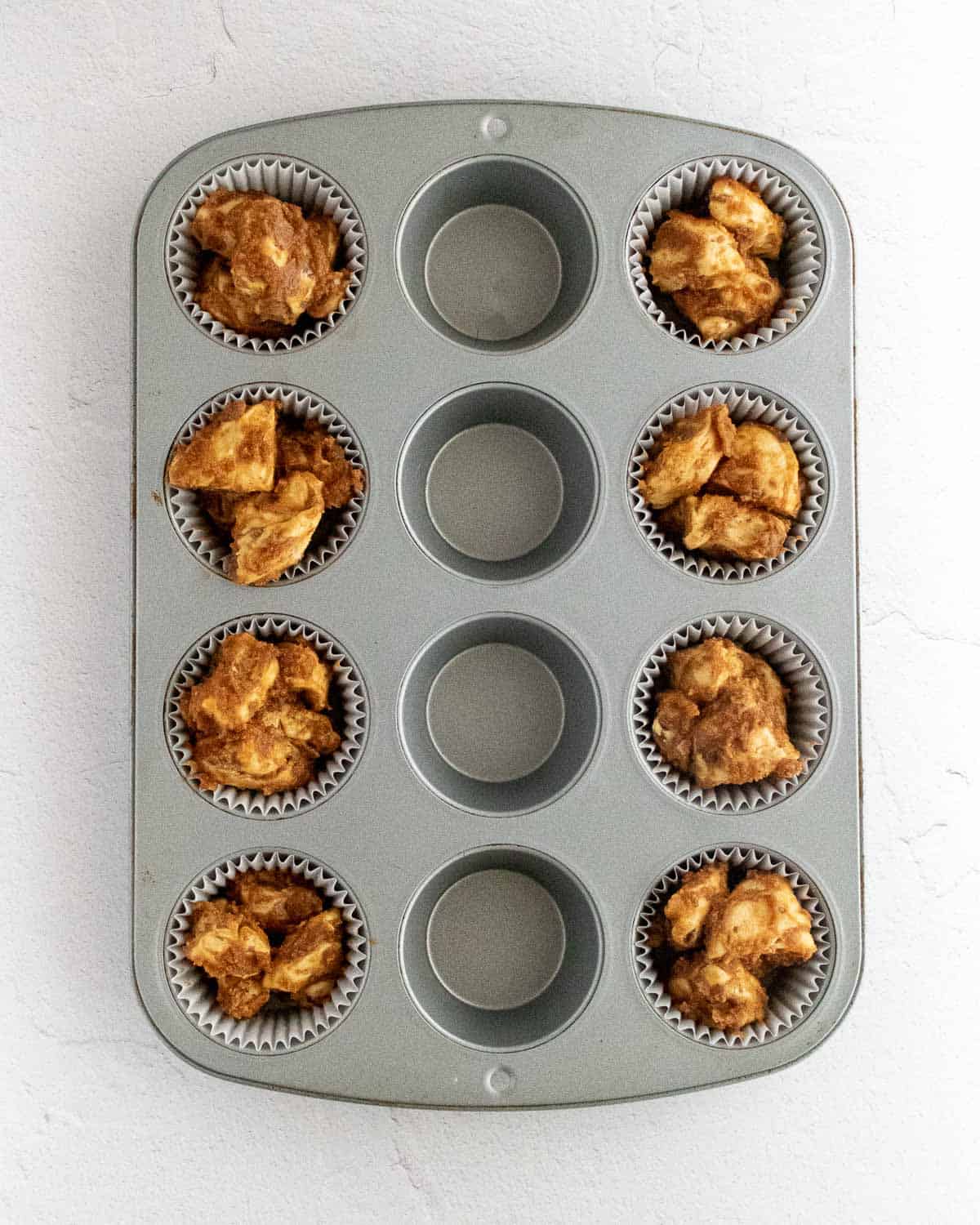 Unbaked pumpkin monkey bread muffins.