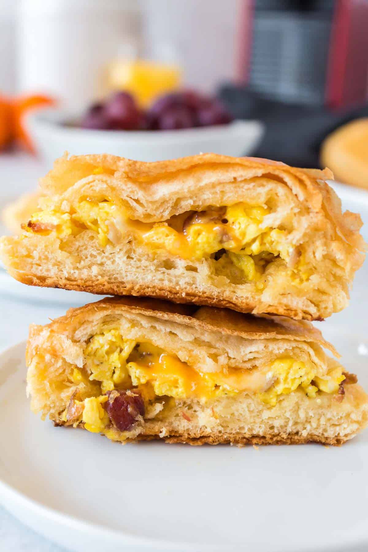 Biscuit split in half to show egg and cheese and meat filling.
