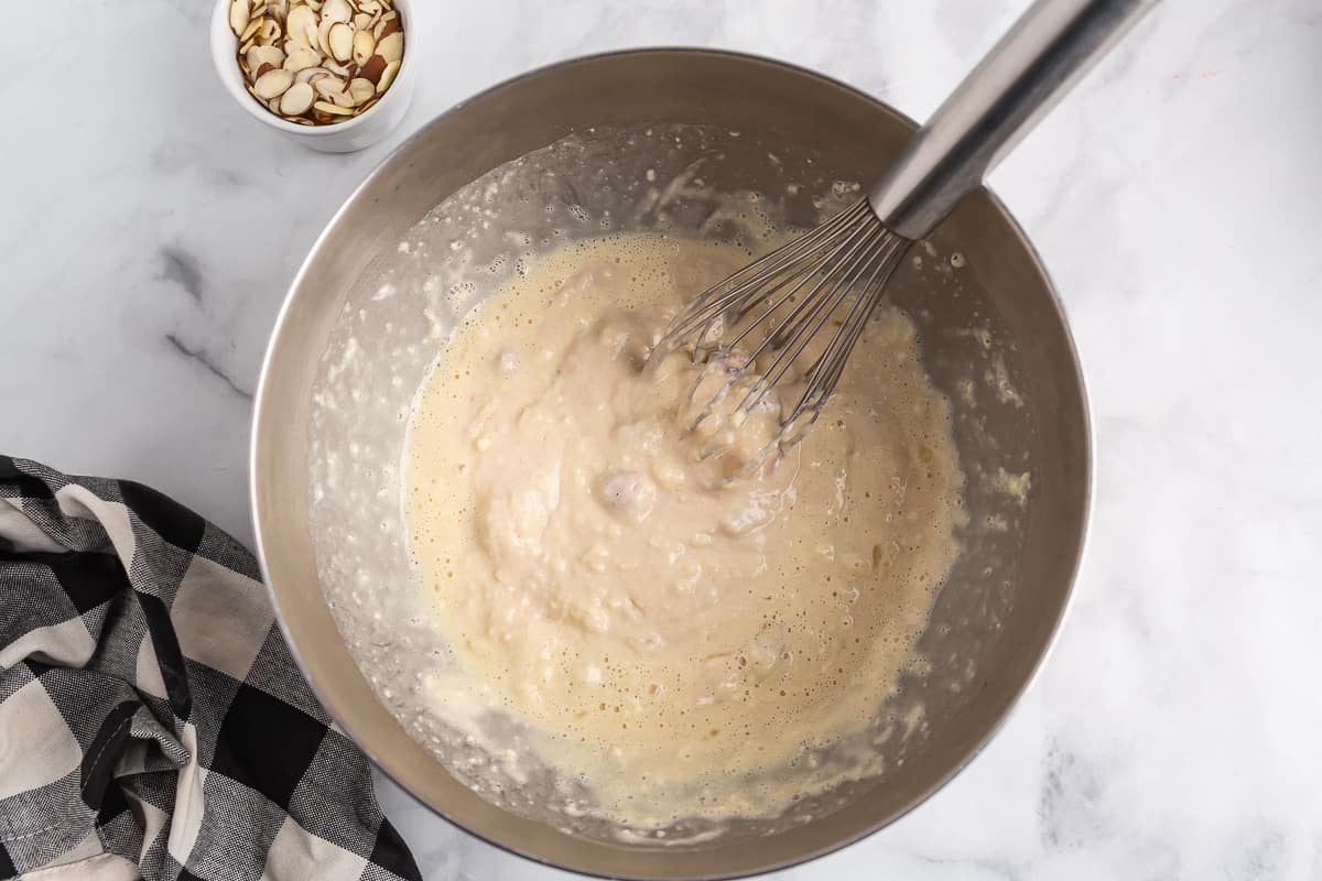Pancake batter in a stainless steel mixing bowl.