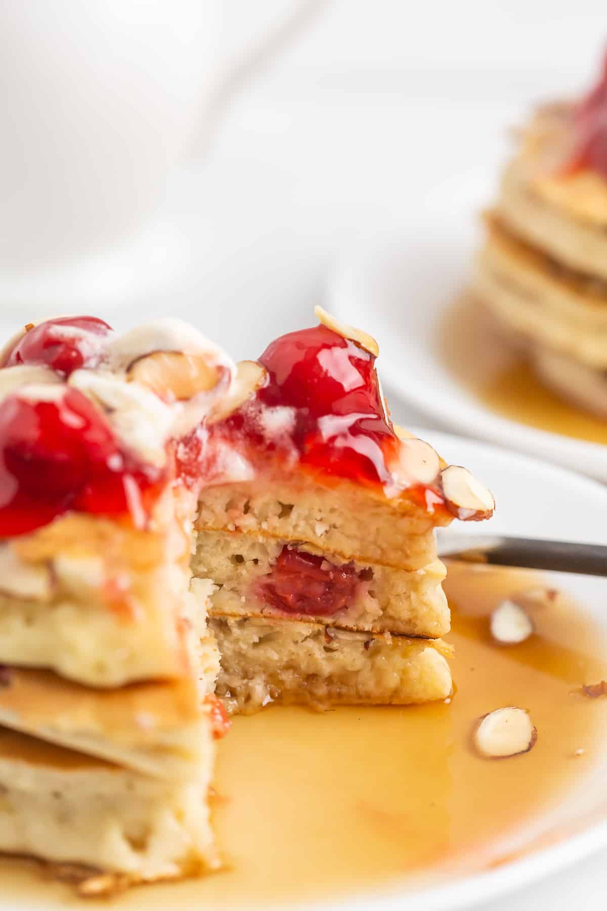 Pancakes with cherries and almonds, a stack of three.