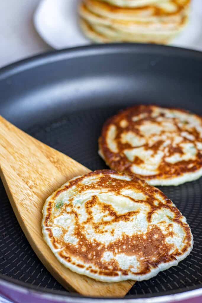 Pancakes being cooked in a frying pan.