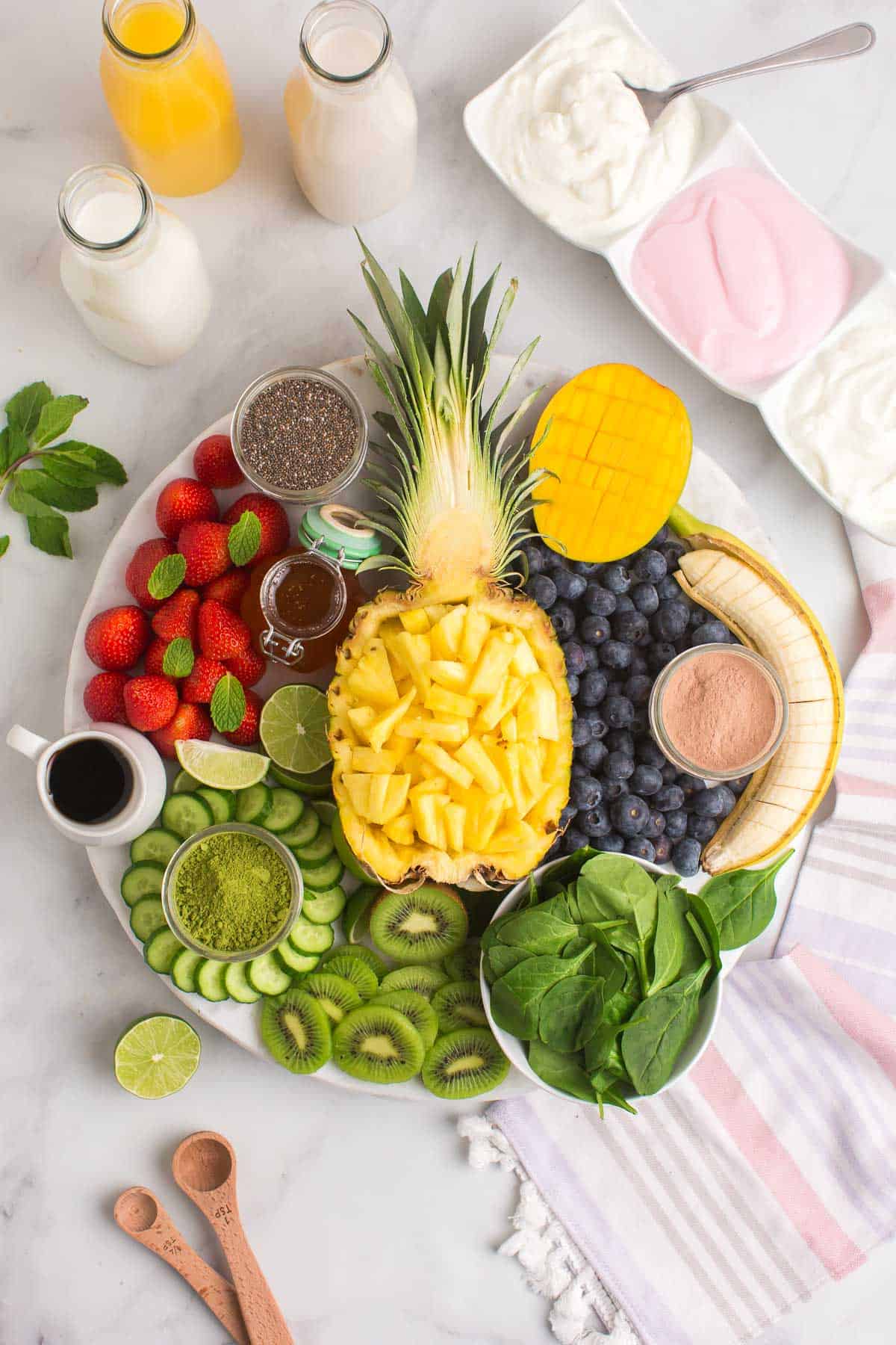 Completed smoothie board with a pineapple half in the middle.