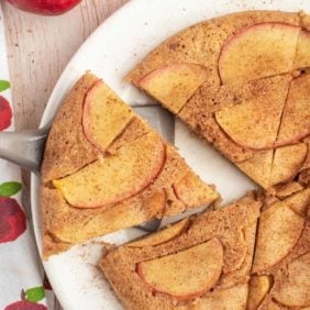 Overhead view of an apple skillet pancake, cut into wedges.