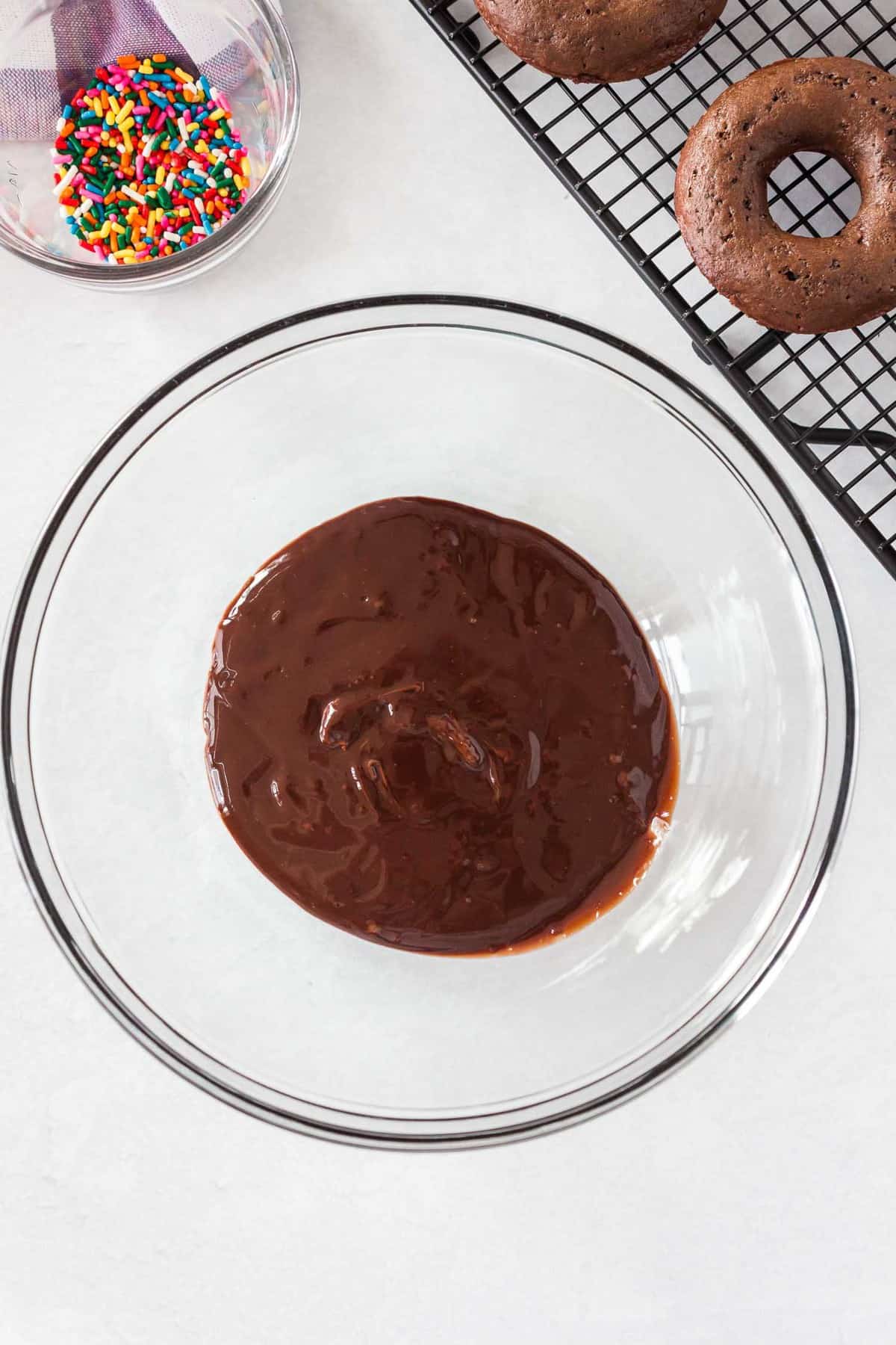 Chocolate glaze in a glass mixing bowl.