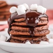 Stack of pancakes with ganache and mini marshmallows.