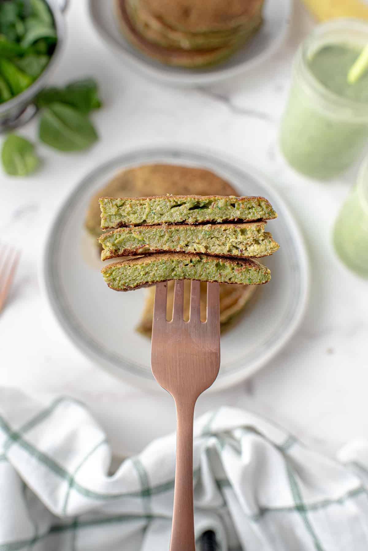 Cut green smoothie pancakes on a fork.