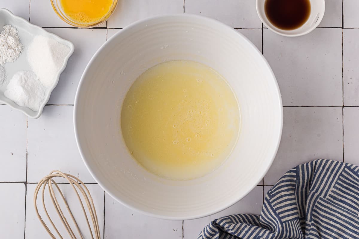 Butter and buttermilk in a white mixing bowl.