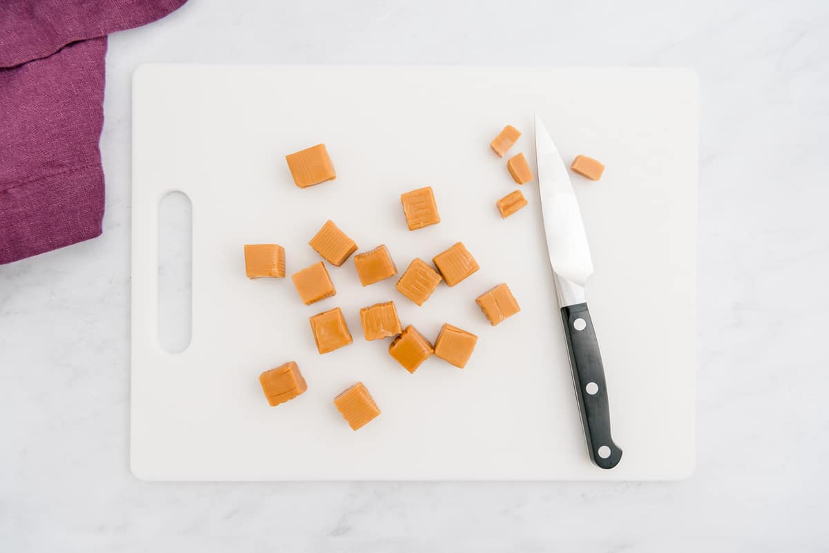 Caramel squares on a cutting board.
