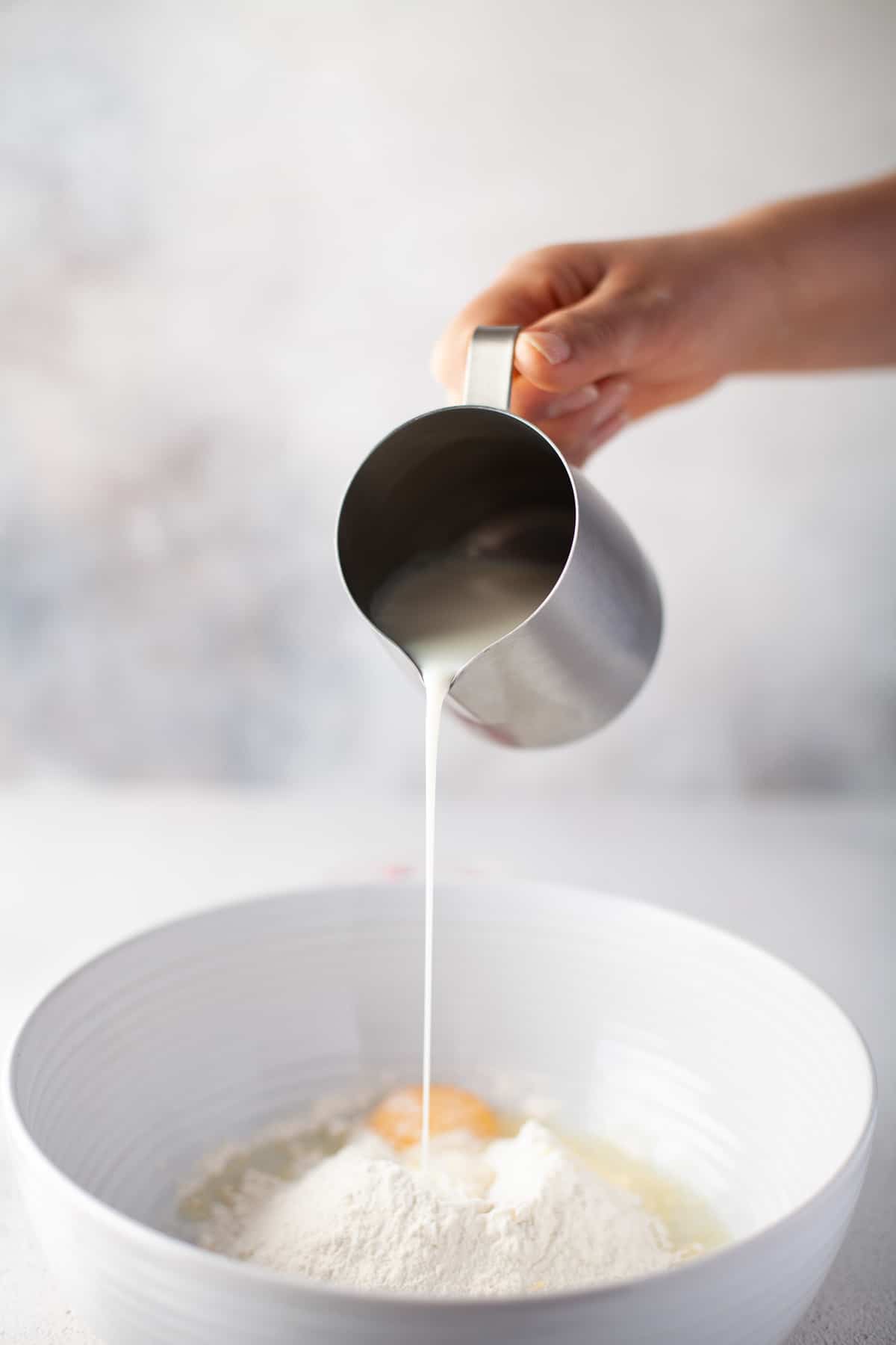 Wet ingredients being added to a bowl.