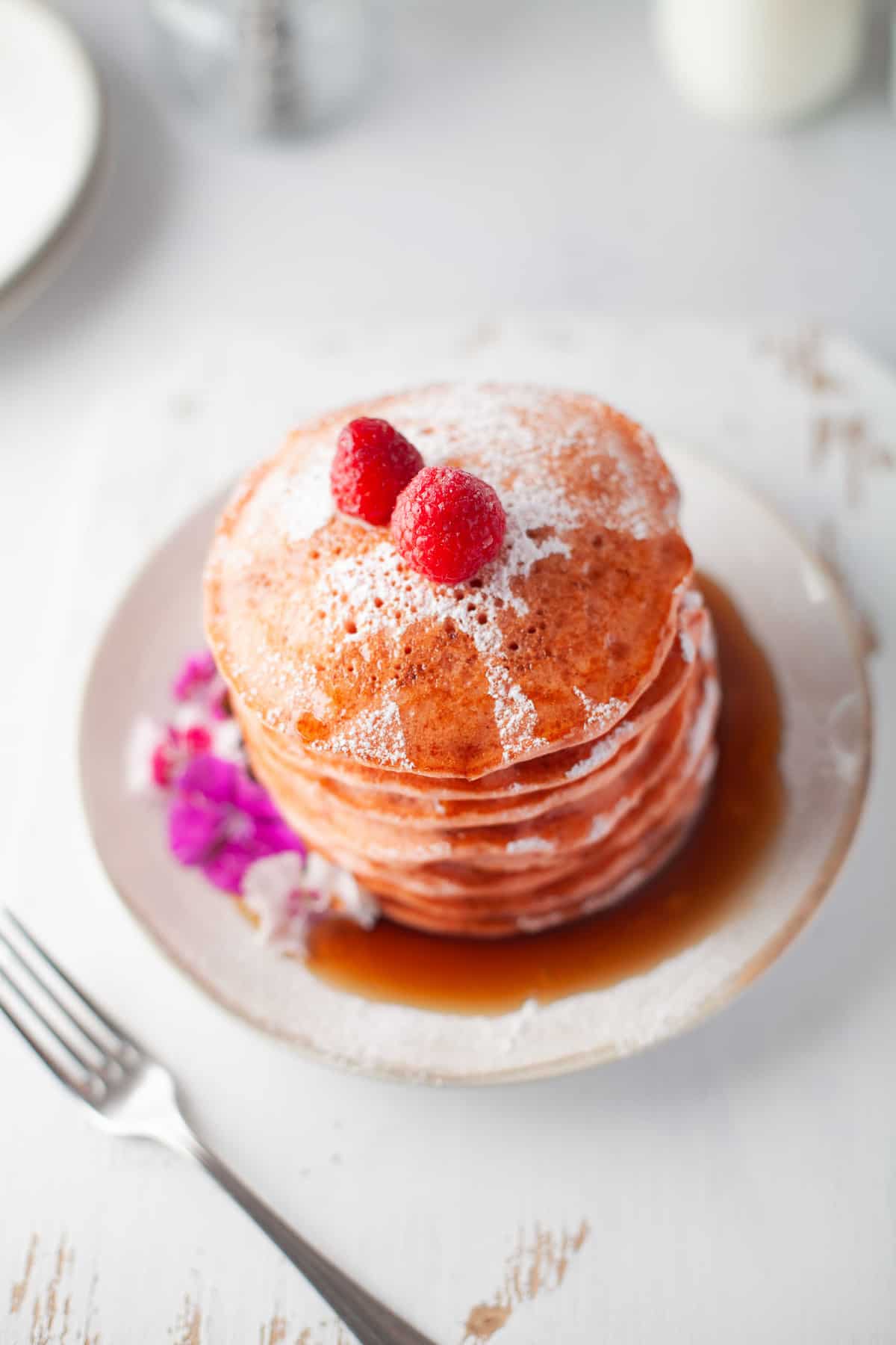 Beet pancakes topped with raspberries.
