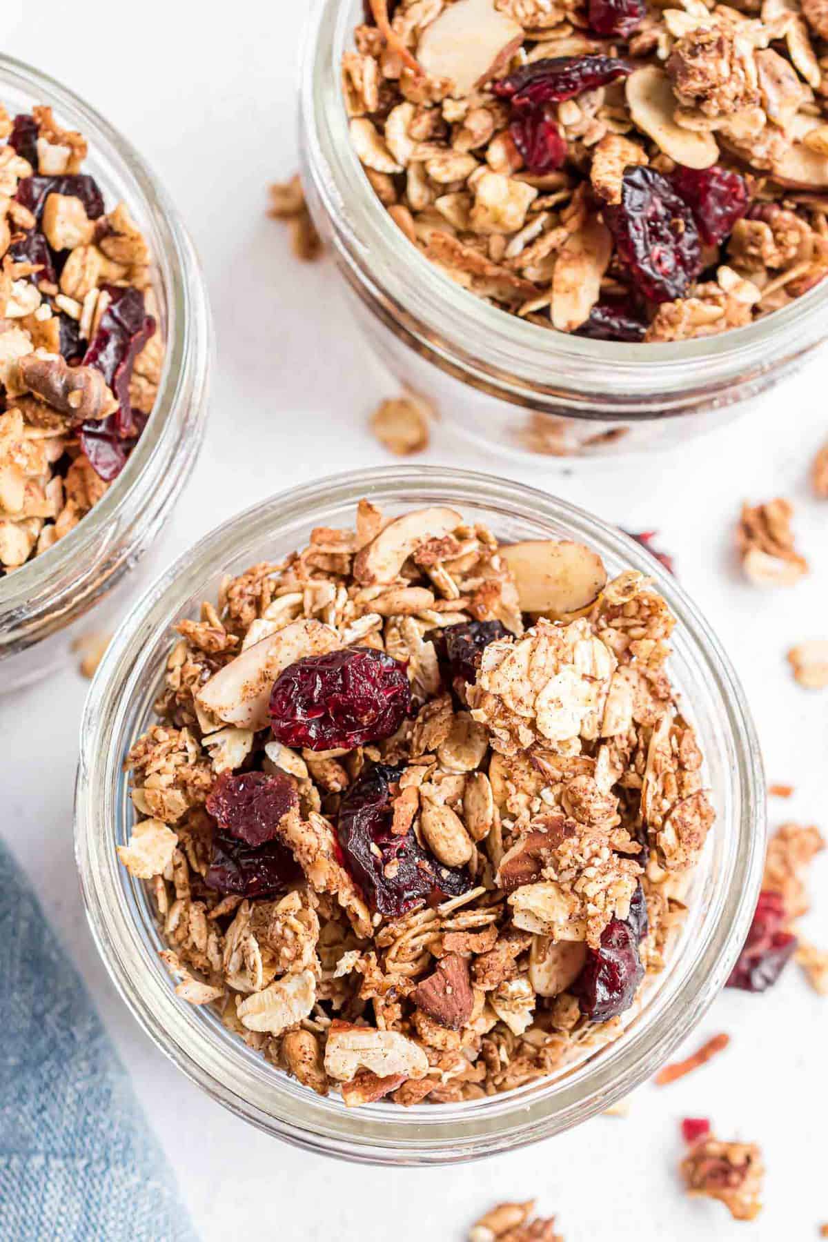Overhead view of granola in small glass jars.