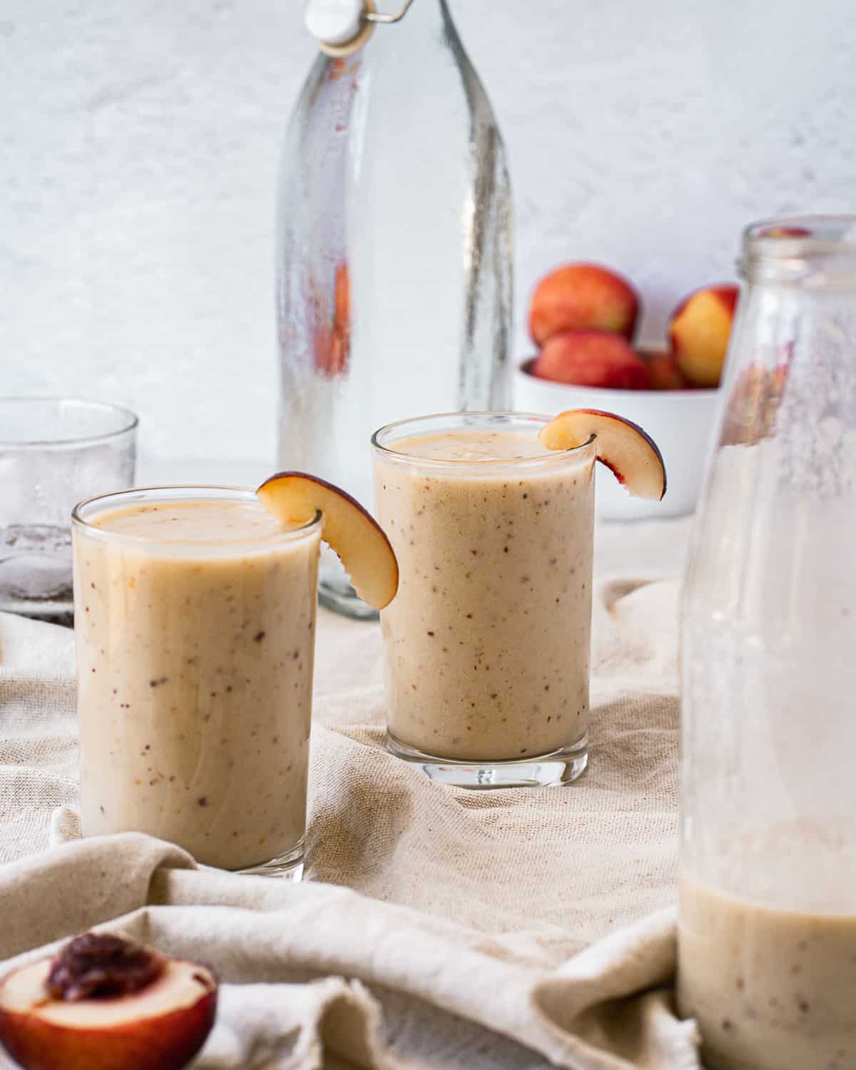 Smoothies with mostly empty bottle in foreground of photo.