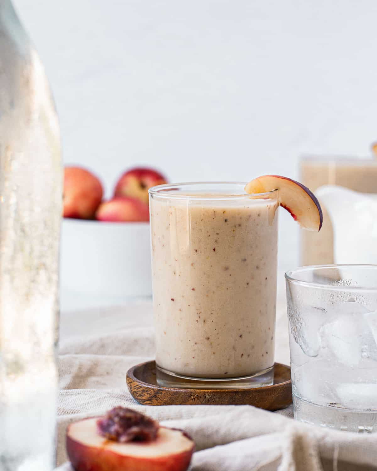 Nectarine smoothie garnished with a slice of nectarine.