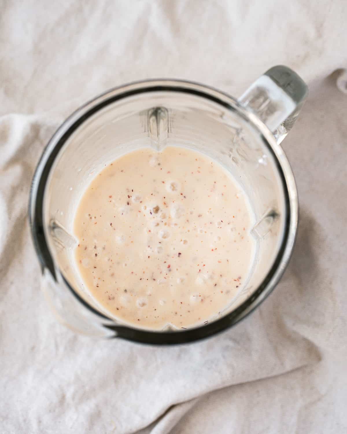 Blended smoothie in a glass blender jar.