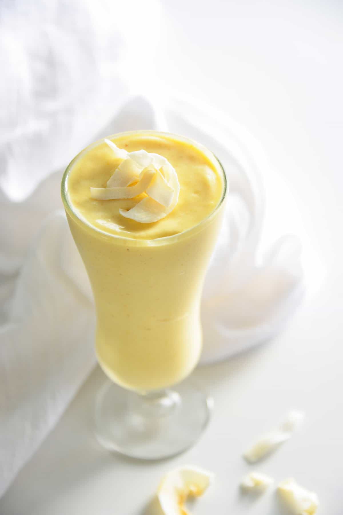 Mango pineapple smoothie topped with coconut.
