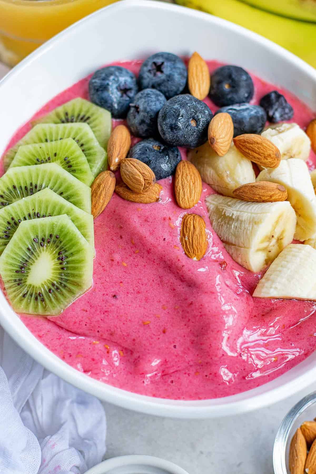 Raspberry smoothie bowl with toppings.