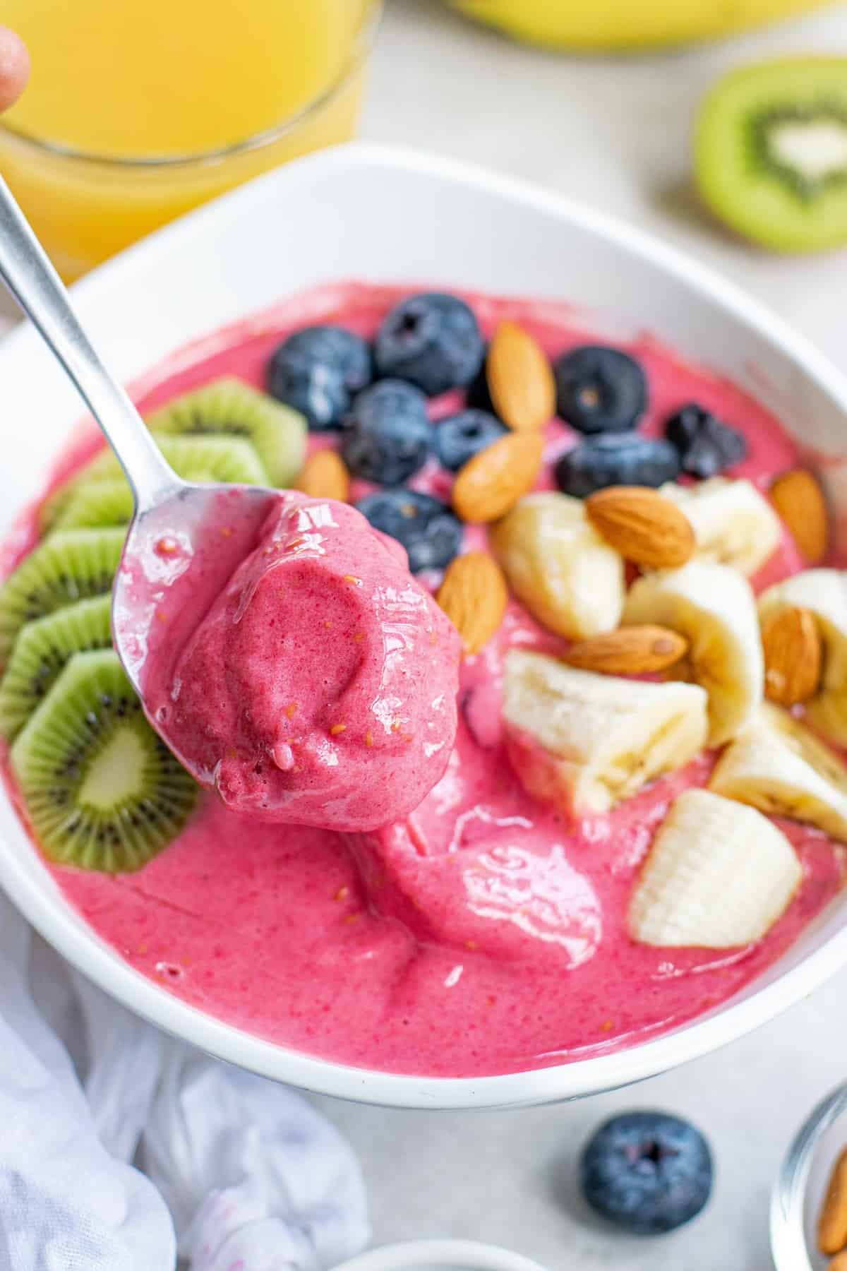 Spoon scooping out some of the smoothie bowl.