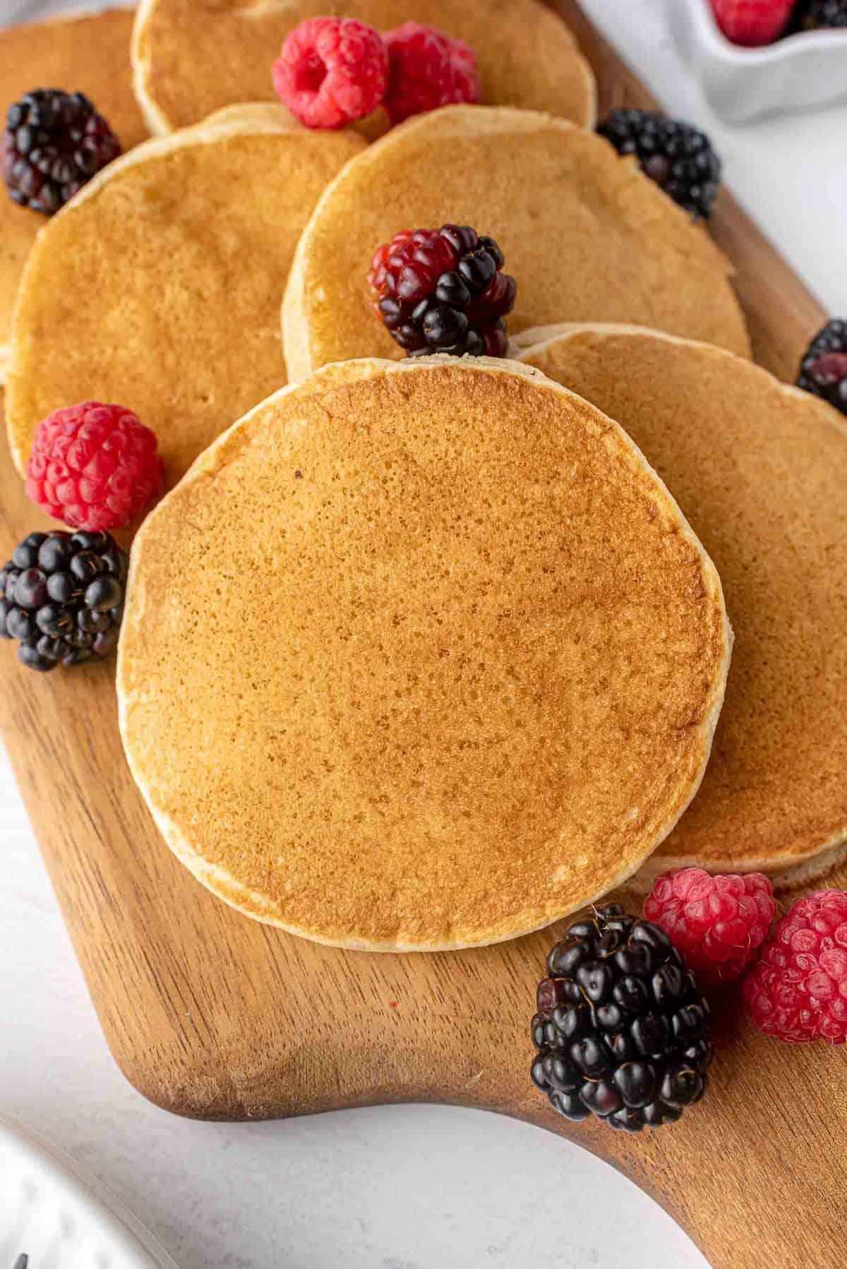 Dairy free pancakes on a wooden platter.