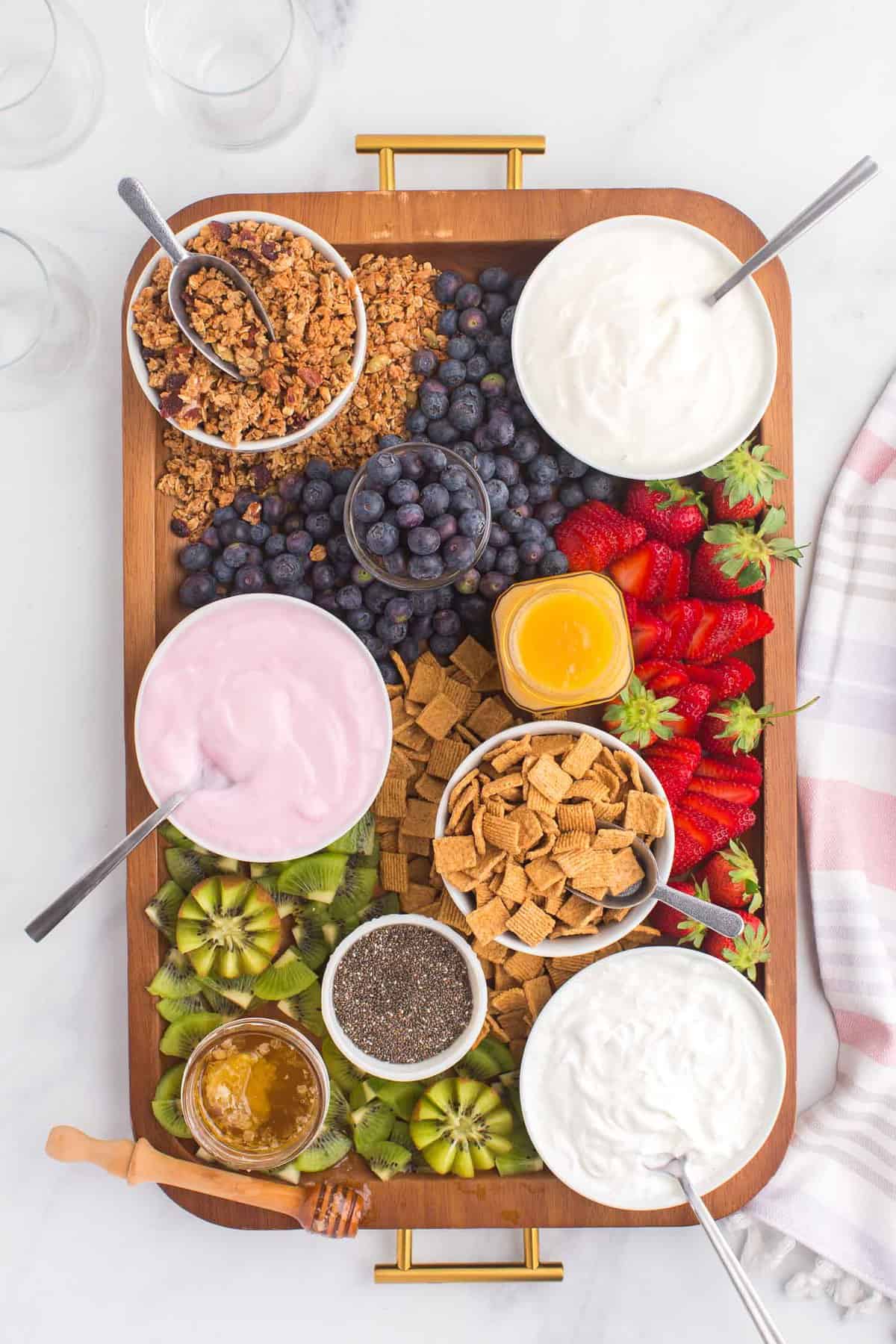 Overhead view of yogurt charcuterie board with three types of yogurt.
