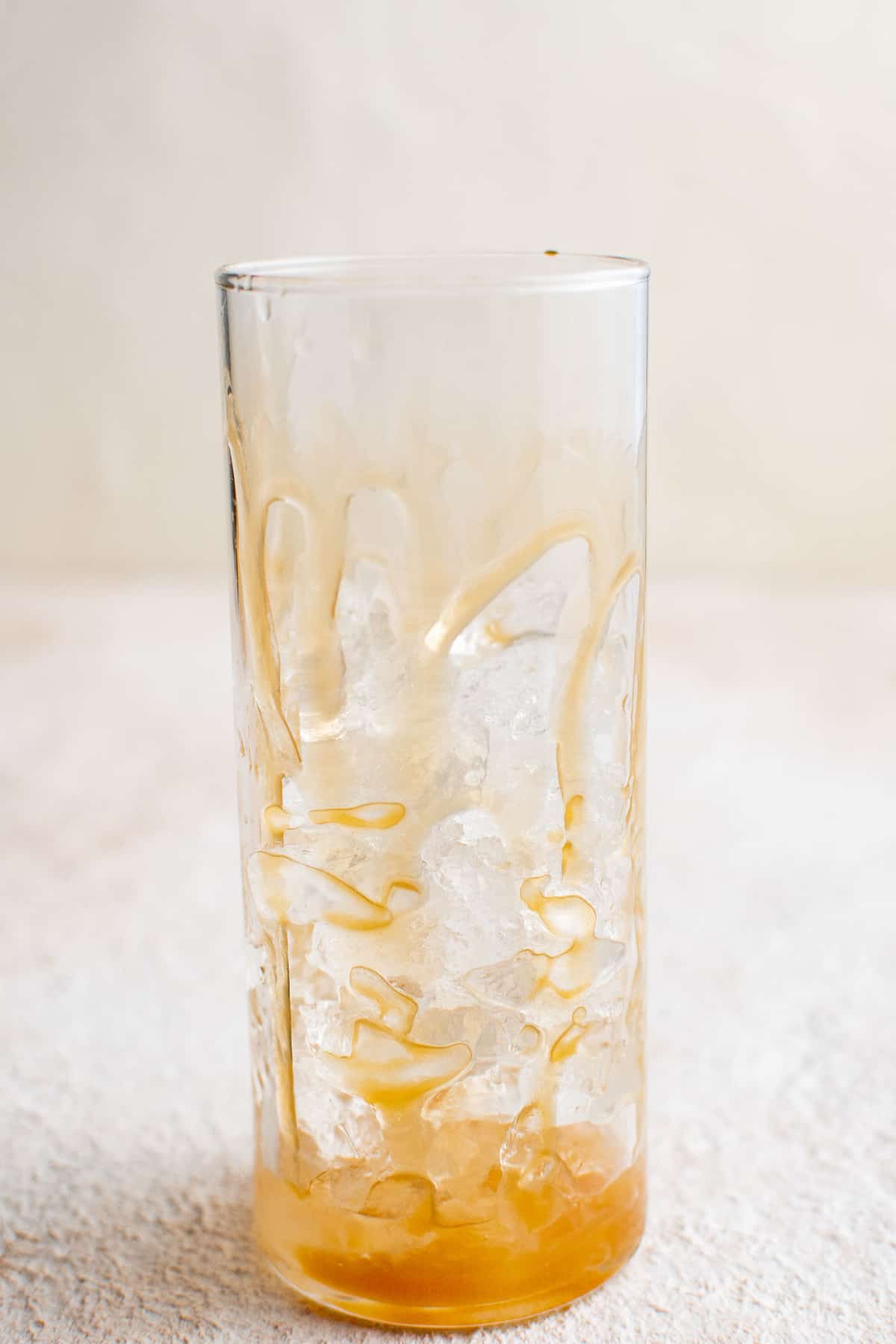 Caramel drizzled in an empty glass.