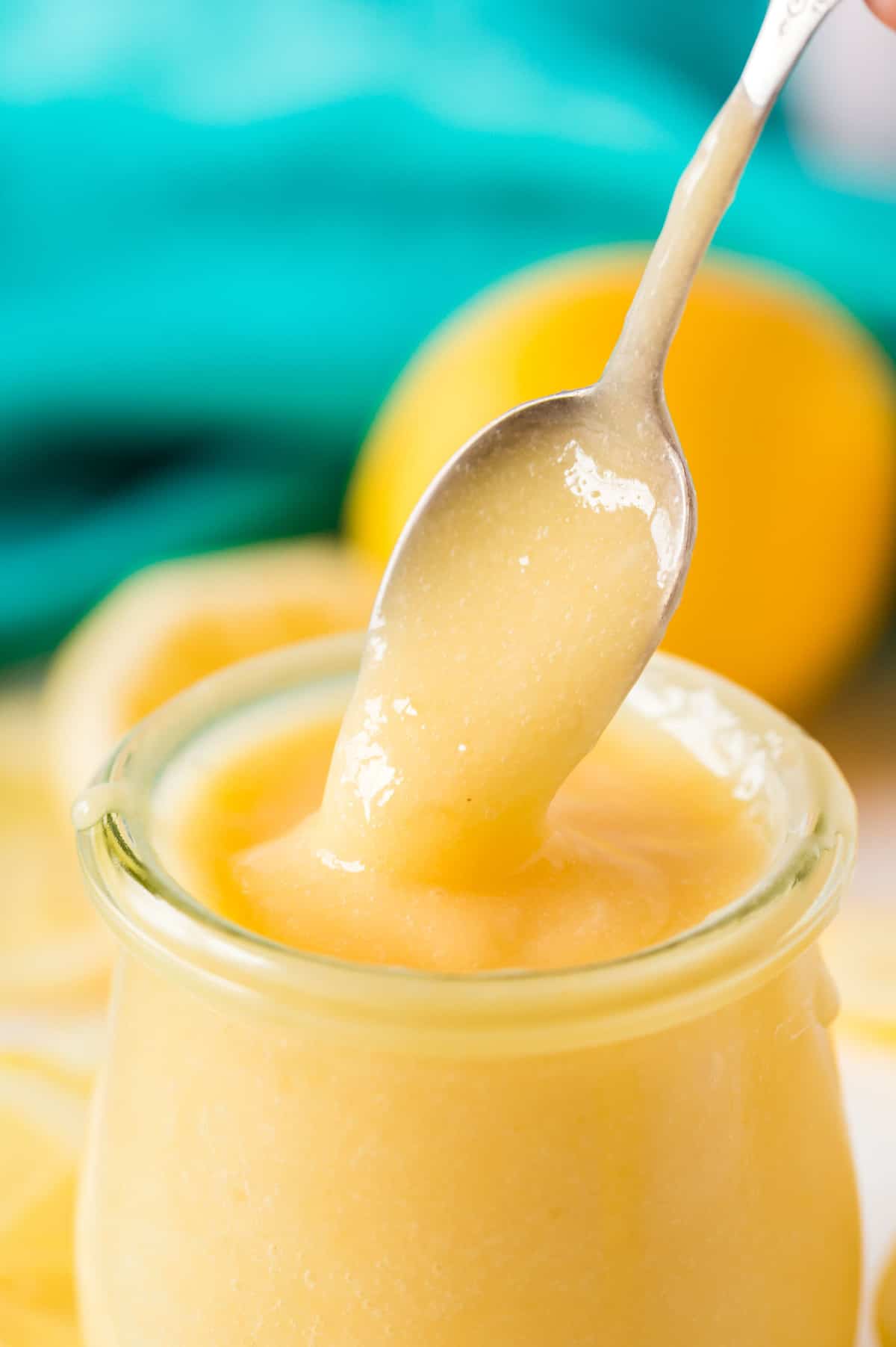 Spoon showing texture of lemon curd.