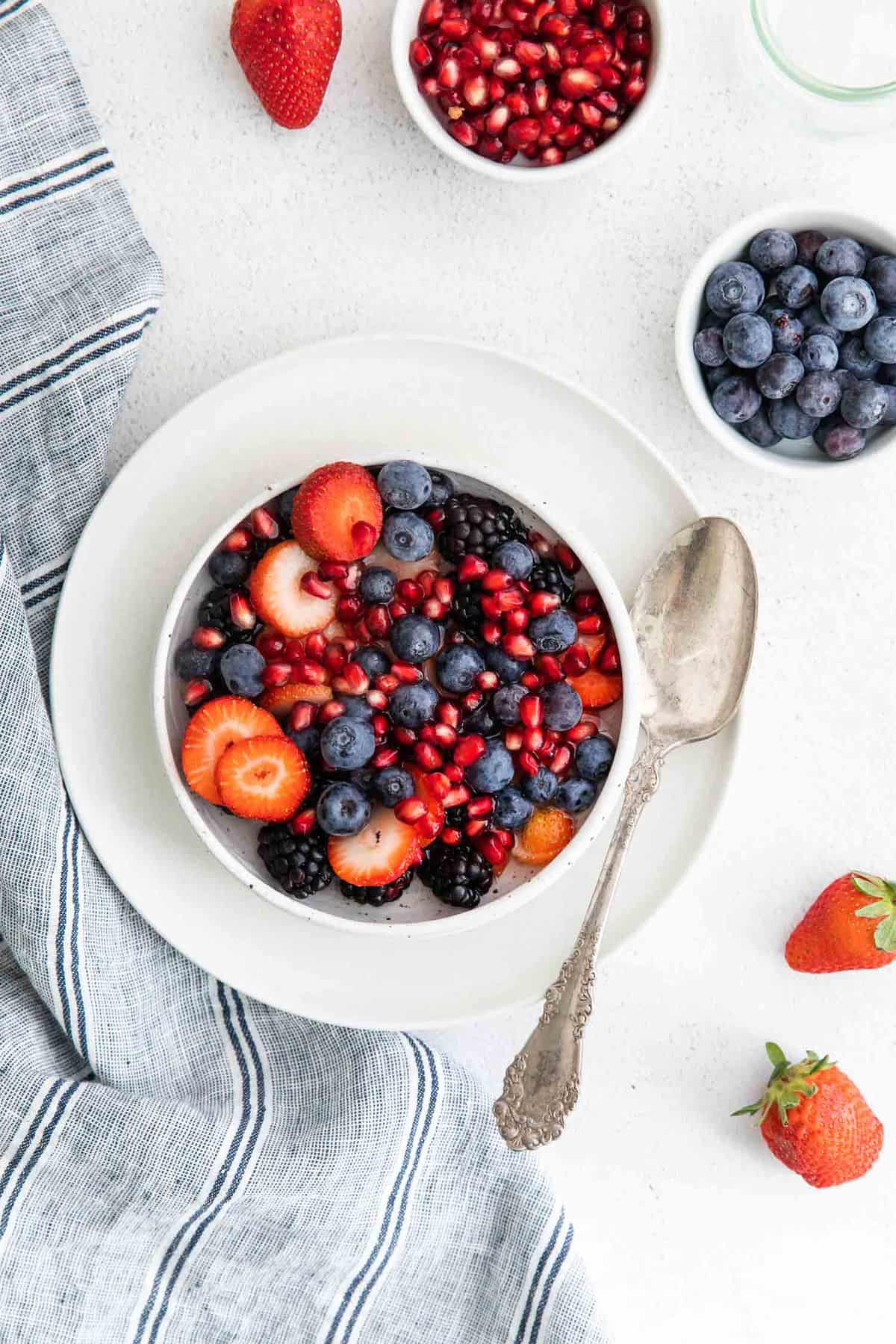 Overhead view of fresh fruit in a bowl with coconut water.