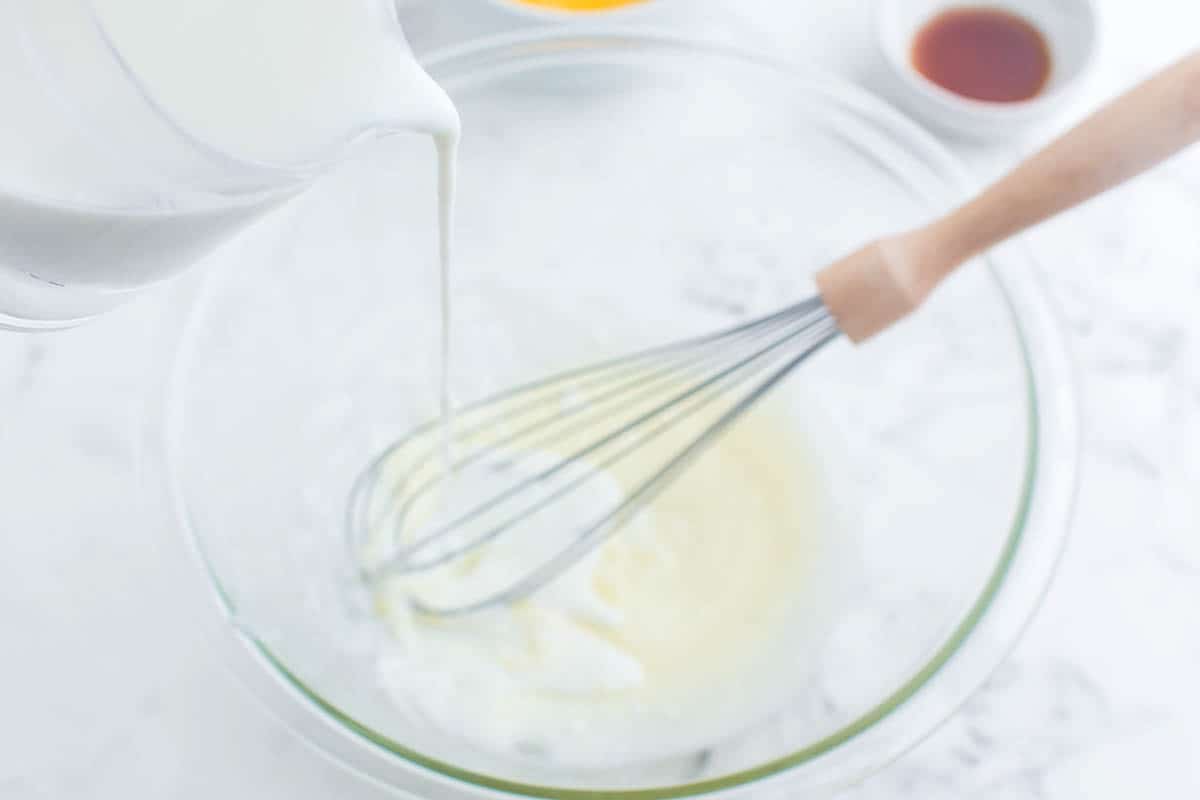 Buttermilk being whisked into melted butter.