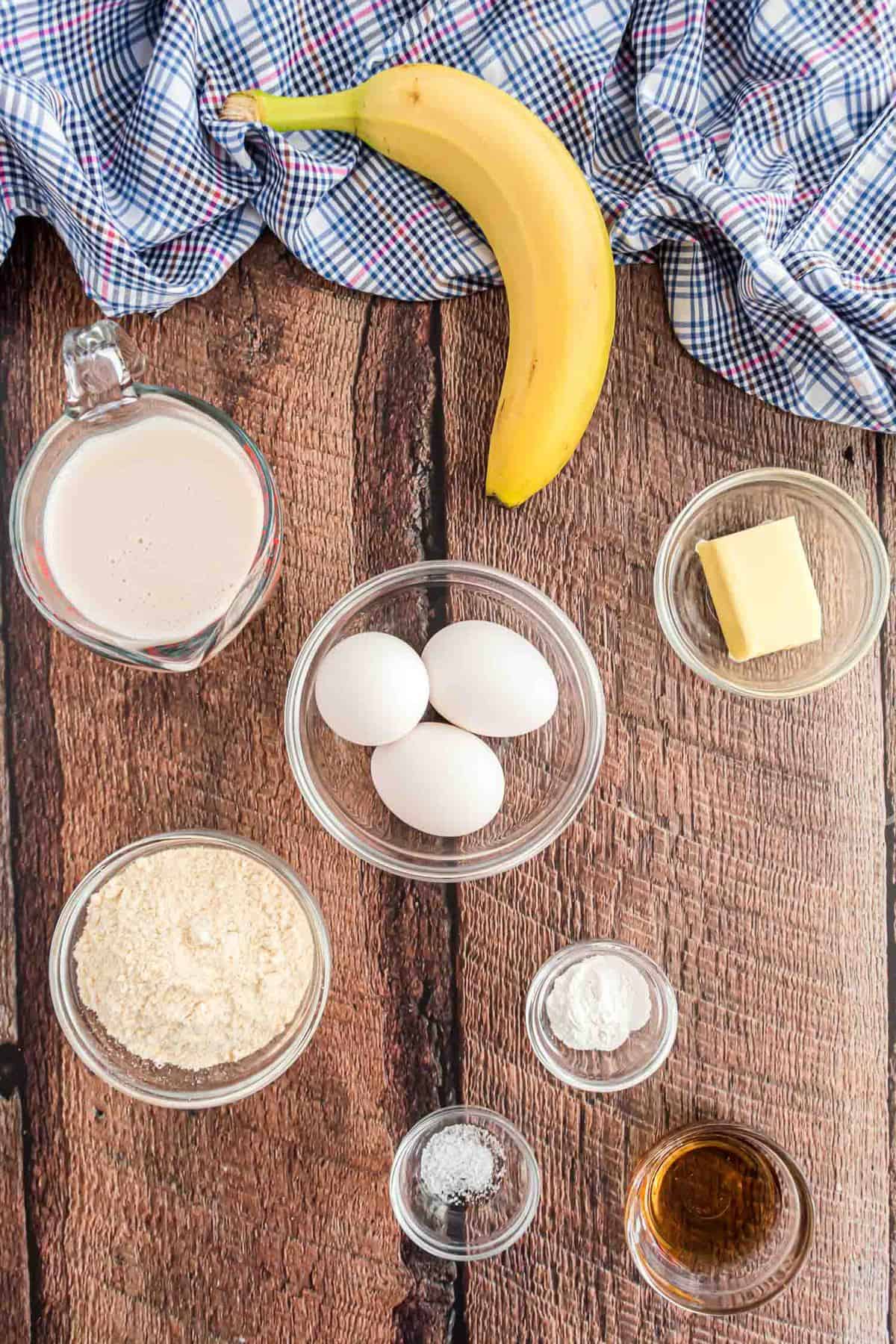 Overhead view of ingredients needed including a banana, eggs, and coconut flour.