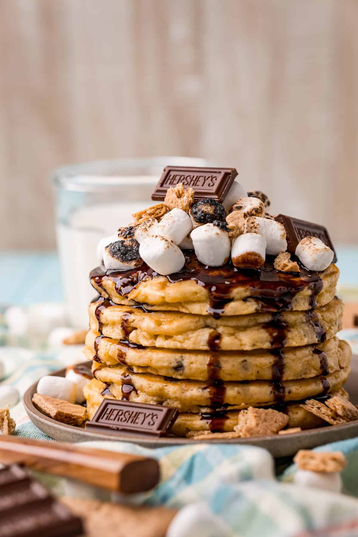 Stack of s'mores pancakes with marshmallows, chocolate, graham cracker.