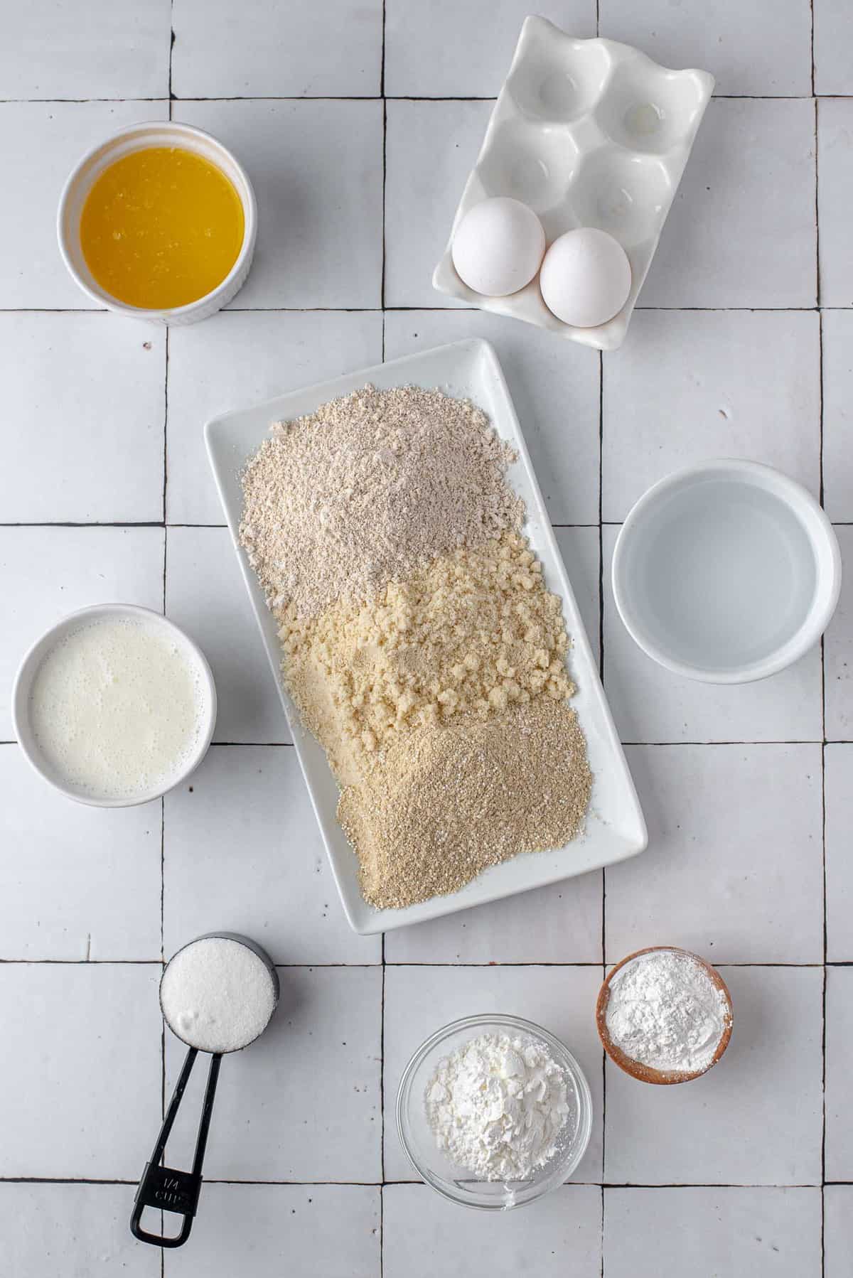 Overhead view of ingredients needed for recipe including three types of gluten-free flours.