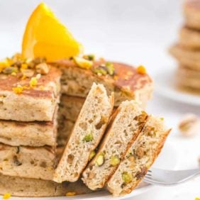 Stack of baklava pancakes with a portion cut out to show texture.